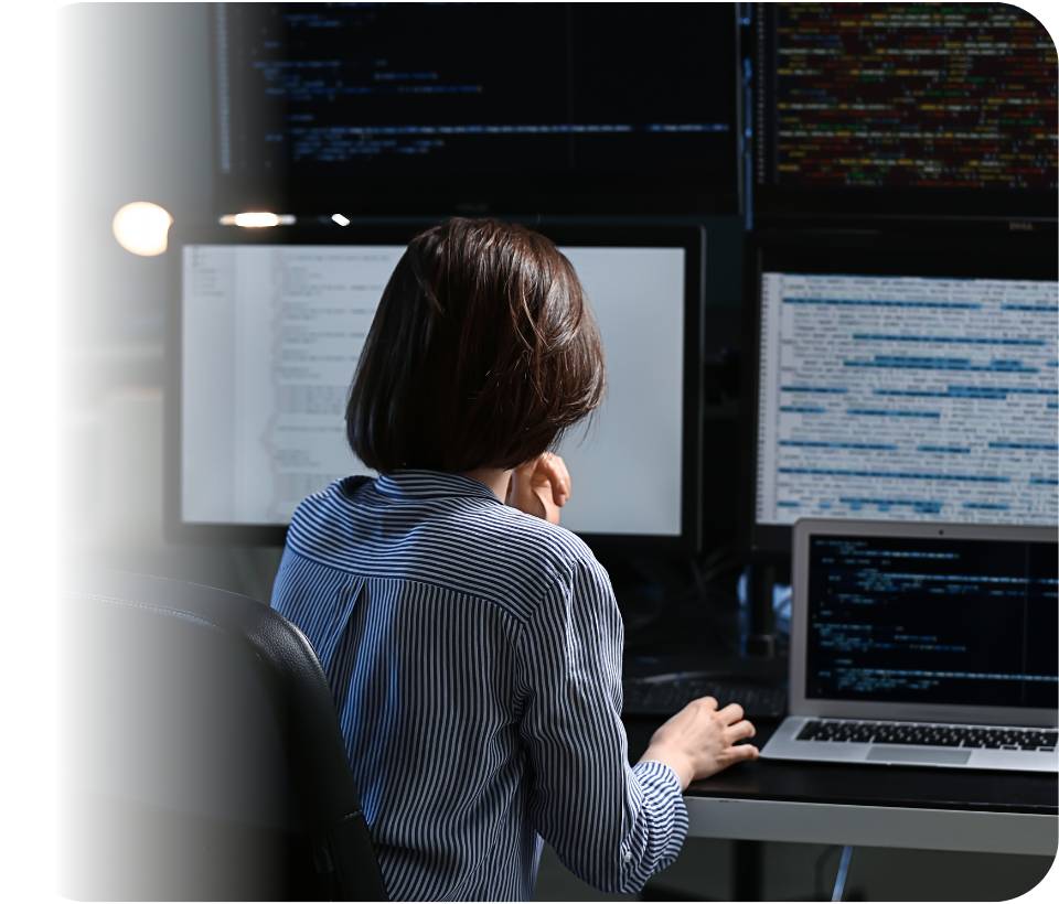 Analyst in front of a wall of monitors